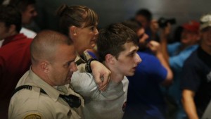 FILE - In this June 18, 2016, file photo, police remove protestor Michael Steven Sandford as Republican presidential candidate Donald Trump speaks at the Treasure Island hotel and casino in Las Vegas. Sandford, a British man accused of trying to take a police officer's gun and kill Donald Trump during a weekend rally in Las Vegas, will not be released on bail. Federal Magistrate Judge George Foley said at a hearing Monday that Sandford was a potential danger to the community and a flight risk. (AP Photo/John Locher, File)